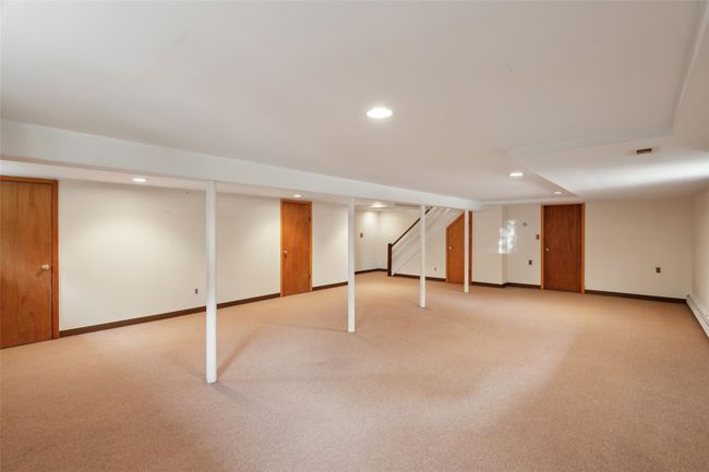 Finished basement featuring baseboards, light carpet, and recessed lighting | Image 32