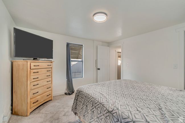 Bedroom featuring light carpet and baseboards | Image 13