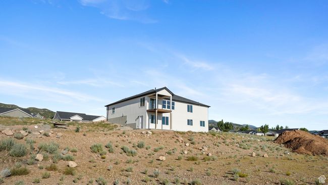 Rear view of property featuring a balcony | Image 27