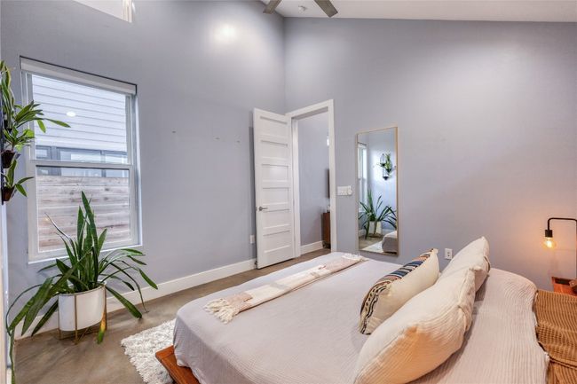 Bedroom featuring a high ceiling, baseboards, and a ceiling fan | Image 9