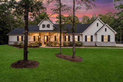 A regal setting, this one-story home greets you and your guests with charm and the welcoming 36' long front porch! | Image 2