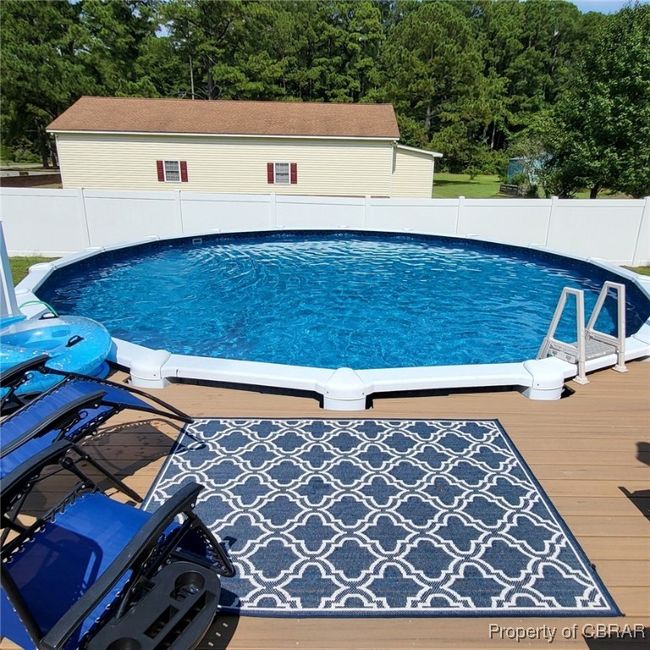 View of swimming pool featuring a fenced backyard | Image 34