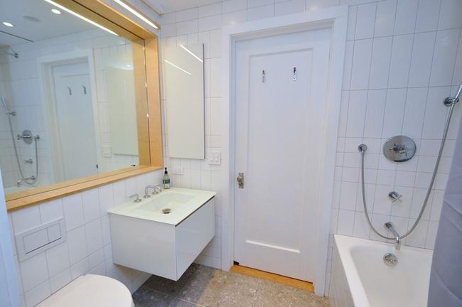Renovated Bathroom has a soaking tub, floating vanity and has access to both the main bedroom and second bedroom. | Image 22
