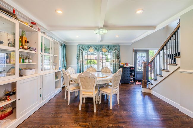 Dining space with dark wood-type flooring, beam ceiling, stairway, recessed lighting, and baseboards | Image 21
