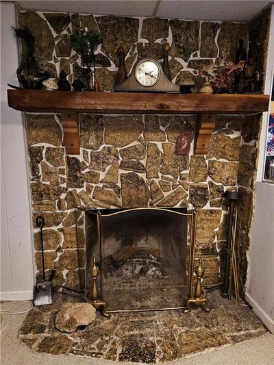 Interior details with carpet flooring and a fireplace | Image 2