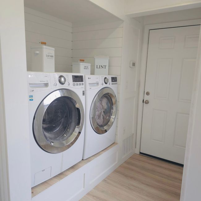 Laundry room with washer and clothes dryer and wood finished floors | Image 13