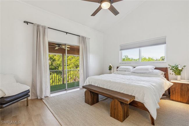 Bedroom with multiple windows, light wood finished floors, ceiling fan, and access to exterior | Image 20