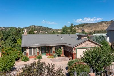 View of front facade with a mountain view and a garage | Image 1