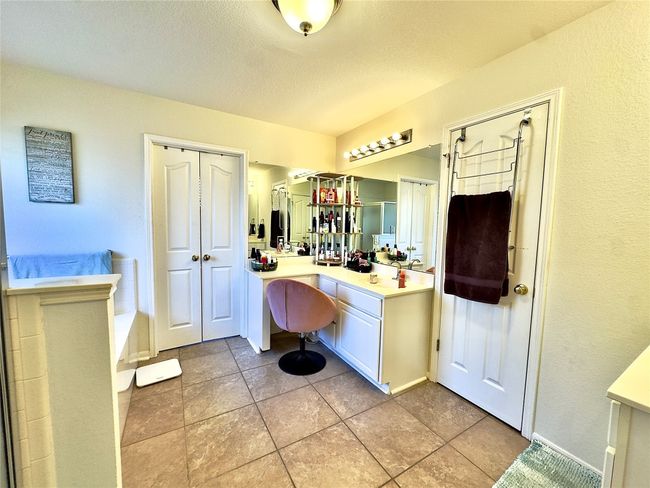 Full bathroom with vanity, baseboards, a textured ceiling, and tile patterned flooring | Image 32