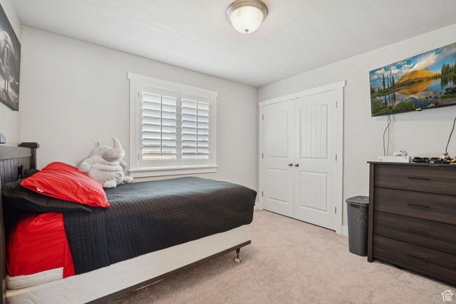 Carpeted bedroom with a closet | Image 22