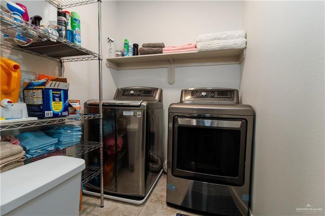 Laundry room featuring laundry area and washing machine and dryer | Image 15