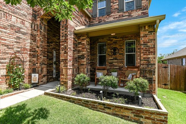 Property entrance featuring covered porch and brick siding | Image 37