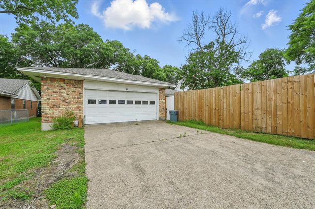 Garage with concrete driveway | Image 29
