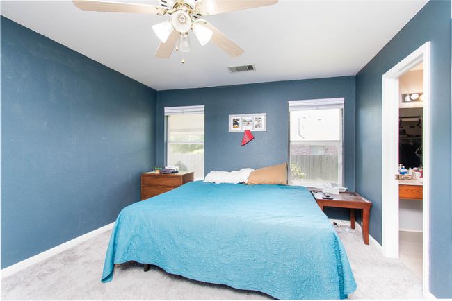 Bedroom with visible vents, baseboards, a ceiling fan, and carpet floors | Image 10