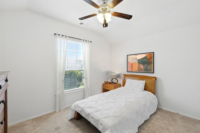 Bedroom featuring lofted ceiling, light carpet, baseboards, and visible vents | Image 7