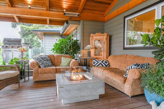 Living room featuring wooden ceiling, hardwood / wood-style flooring, and wooden walls | Image 16