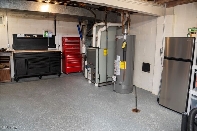 Unfinished below grade area featuring gas water heater, and heating unit | Image 45
