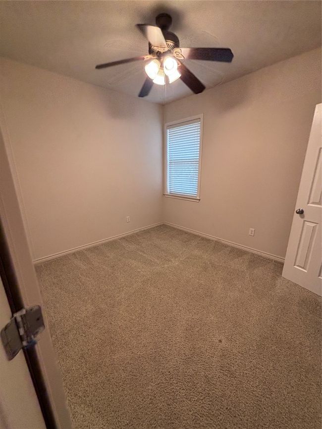 Unfurnished bedroom with carpet flooring and a ceiling fan | Image 10