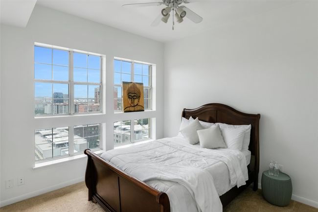 Carpeted bedroom featuring a city view and a ceiling fan | Image 23