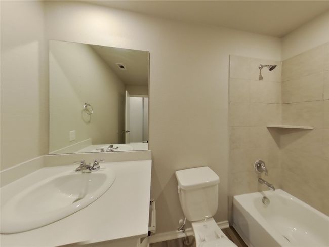 Bathroom featuring toilet, tub / shower combination, and vanity | Image 11