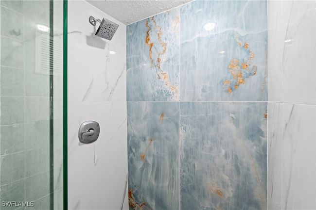 Full bathroom featuring a stall shower and a textured ceiling | Image 15