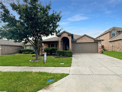 Ranch-style home featuring a garage and a front yard | Image 2