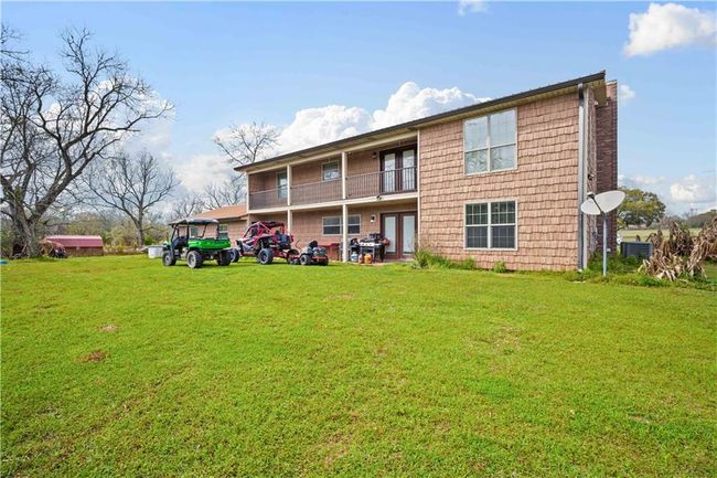 Back of house featuring a balcony, central AC, and a yard | Image 29