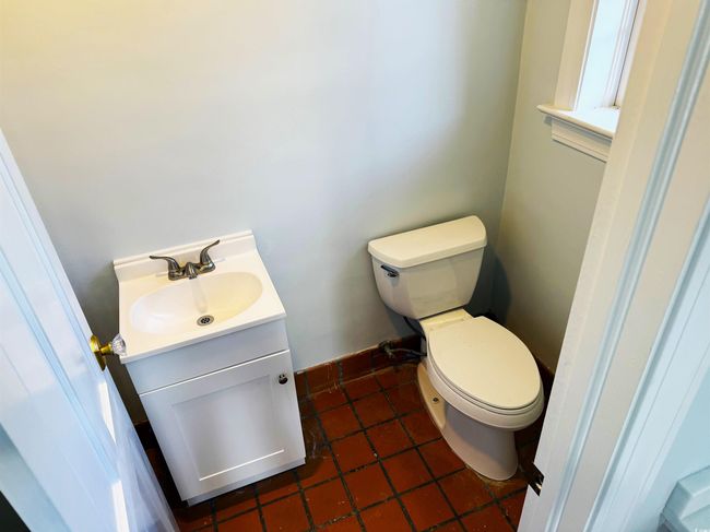 Bathroom with toilet, vanity, and tile patterned flooring | Image 26