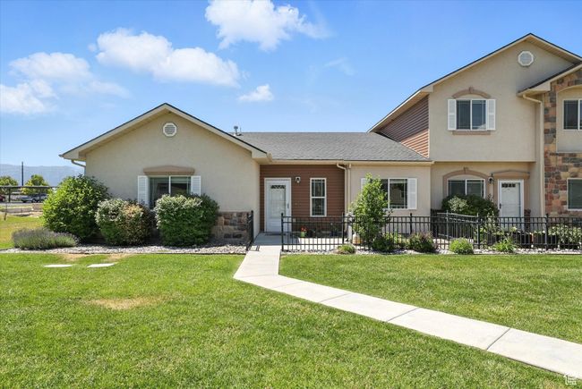 View of front of house with stone siding, stucco siding, and a shingled roof | Image 24