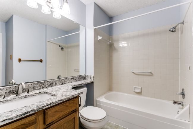 Bathroom with shower / tub combination, vanity, and a textured ceiling | Image 21