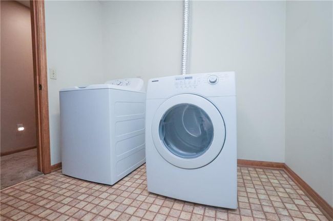 Laundry area featuring washer and dryer and light flooring | Image 27