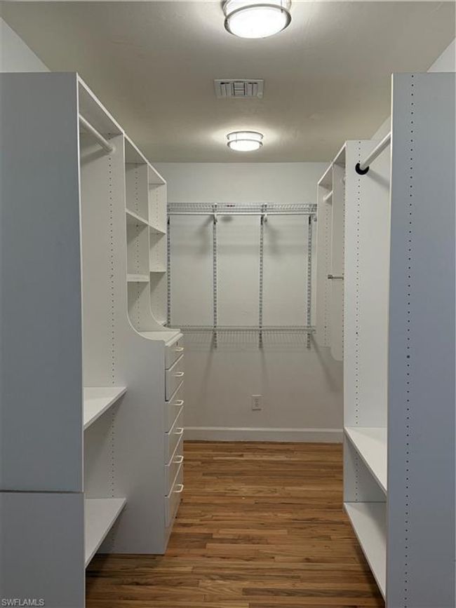 Large walk-in master closet with built in shelving! | Image 18