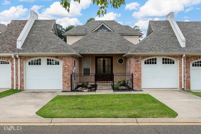 View of front of home with a front yard and a garage | Image 1