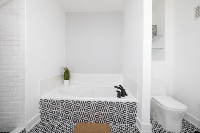 Bathroom with a garden tub and tile patterned floors | Image 33
