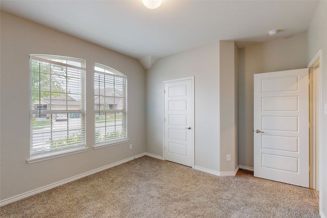Unfurnished bedroom with light colored carpet and baseboards | Image 22