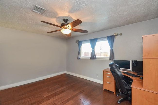 Bedroom #4- currently used as an office- spacious with closet and ceiling fan | Image 19