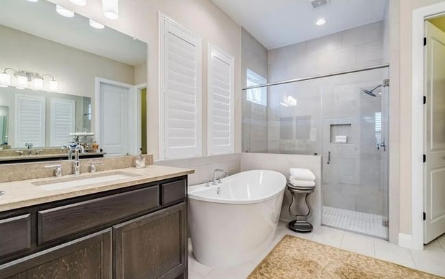 Primary owner bathroom suite with tub and step in shower, dual split vanities | Image 15