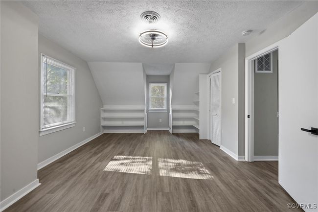 2nd floor bedroom featuring wood finished floors and a desk | Image 32