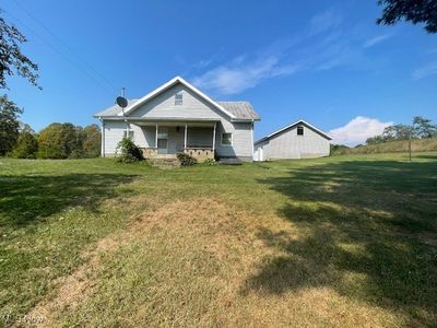 View of front of property with a porch and a front yard | Image 1