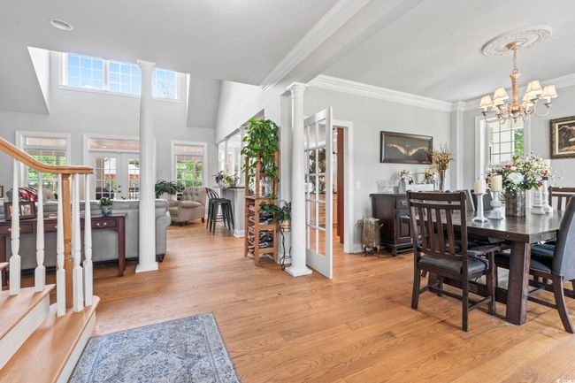 Dining room with french doors, light wood-style flooring, ornamental molding, and plenty of natural light | Image 6