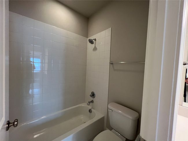 Bathroom featuring toilet and shower / washtub combination | Image 17