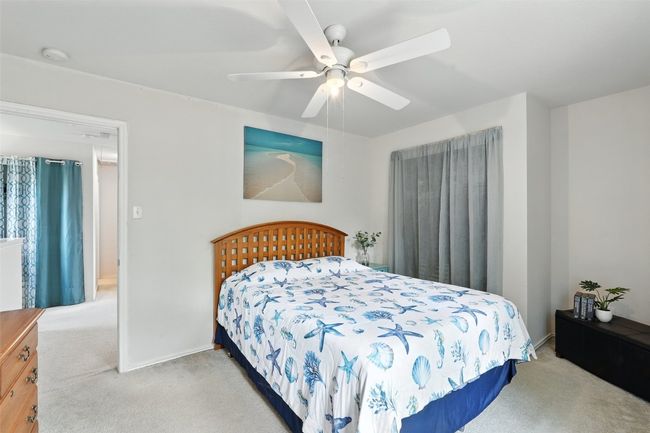 Bedroom featuring light colored carpet and a ceiling fan | Image 20