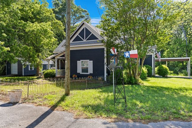 View of front of home with fence, roof with shingles, and a front yard | Image 38