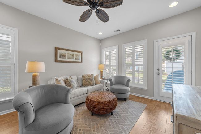 Living room with a ceiling fan, light wood finished floors, recessed lighting, and baseboards | Image 21