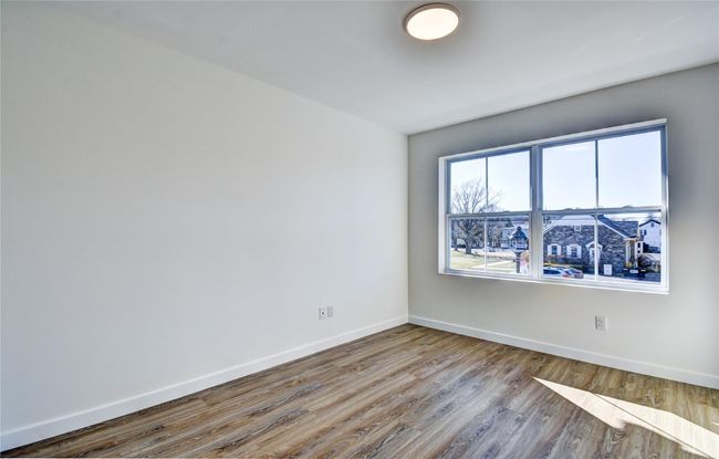Spare room featuring baseboards and wood finished floors | Image 35
