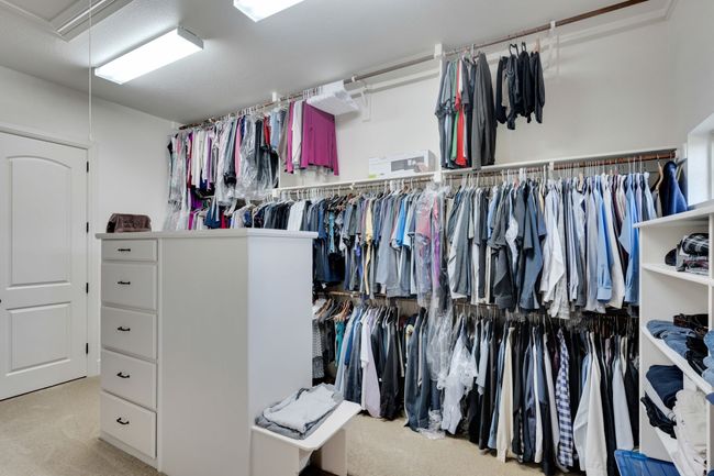 Spacious closet with carpet floors and attic access | Image 24