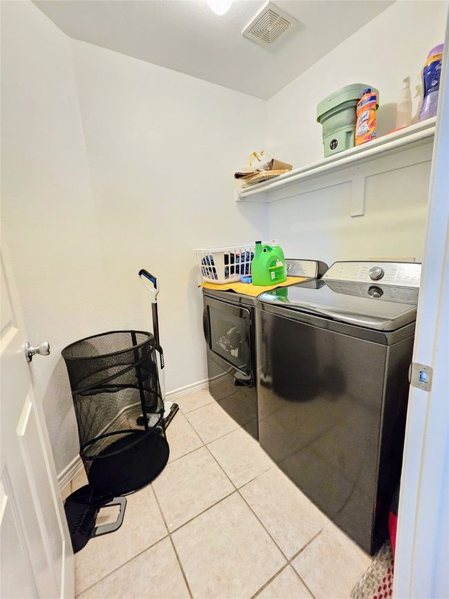 Washroom featuring washing machine and dryer and light tile patterned floors | Image 28