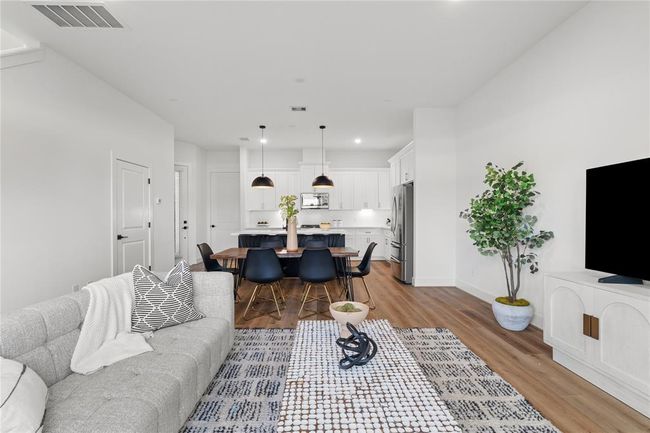 The airy layout is enhanced by high ceilings and strategically placed recessed lighting, creating a bright and inviting atmosphere. | Image 12