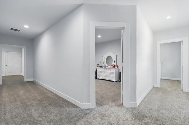 Hall with carpet, baseboards, and recessed lighting | Image 31