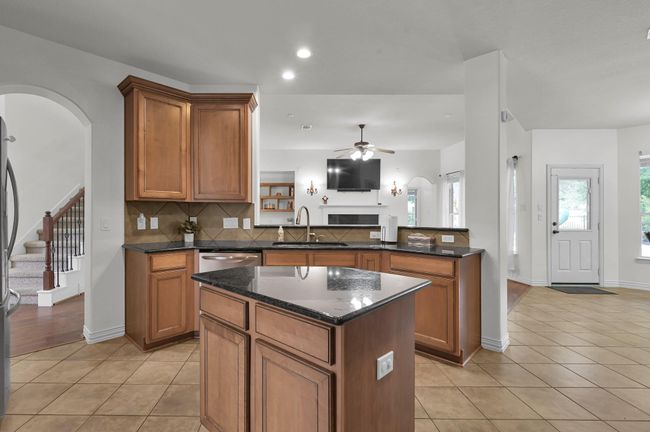 The open design is perfect for watching TV and staying connected with family and guests. The central island will be your best friend for cooking and daily meal prep! | Image 15